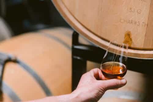 Whiskey pouring from barrel